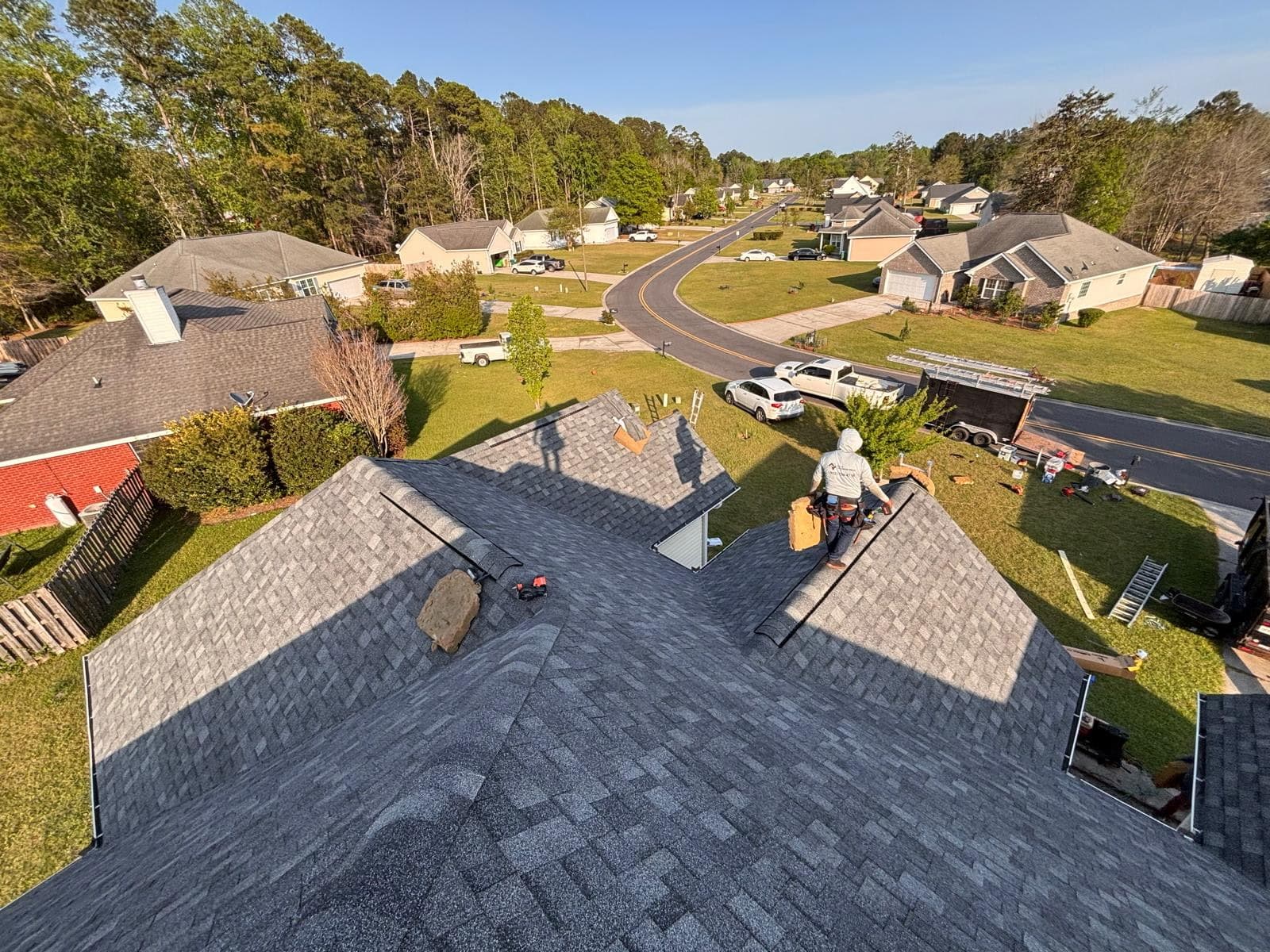 Premier Roofing and Exterior Quality Aerial view of the Tucker Contractors crew installing a new architectural shingle roof on a residential home