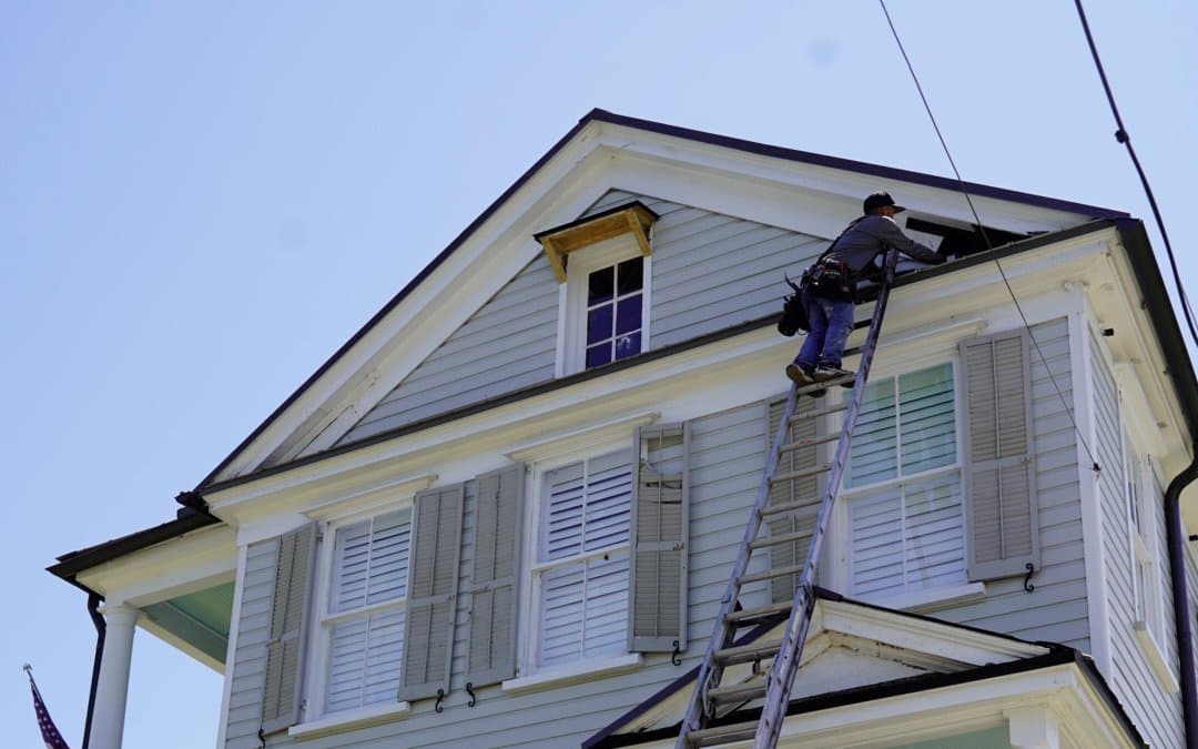 Comprehensive Exterior Services & Quality Craftsmanship Tucker Contractors crew performing fascia and gutter service on a historic Charleston home